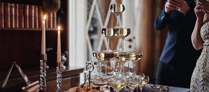 Bottle of Champagne in Holder with 2 Filled Glasses on A Silver Tray