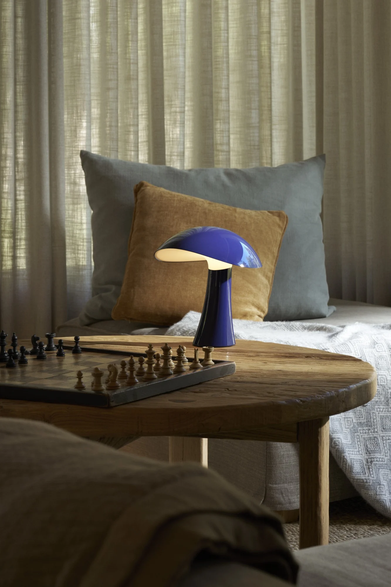A bright blue lamp from Louis Poulsen placed on a living room table, reflecting the interior colour trends for 2026.