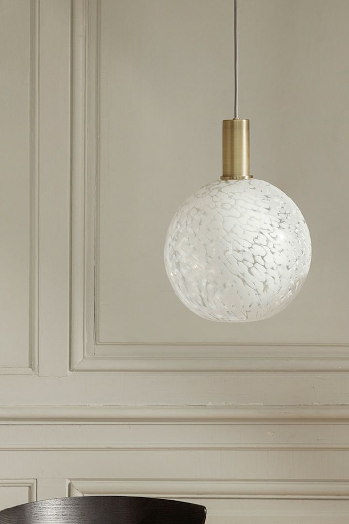 Spring's interior design trends 2023 offer the polka dot pattern trend where we like to decorate with a polka dot lamp from ferm LIVING in our homes like this one in white.