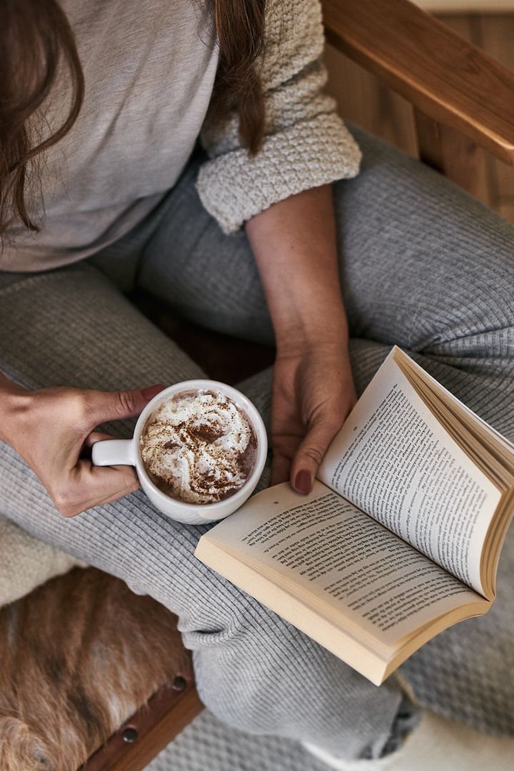 Scandinavian lifestyle things to try this winter - reading a book by the fire with the Fossil mug from Scandi Living. 