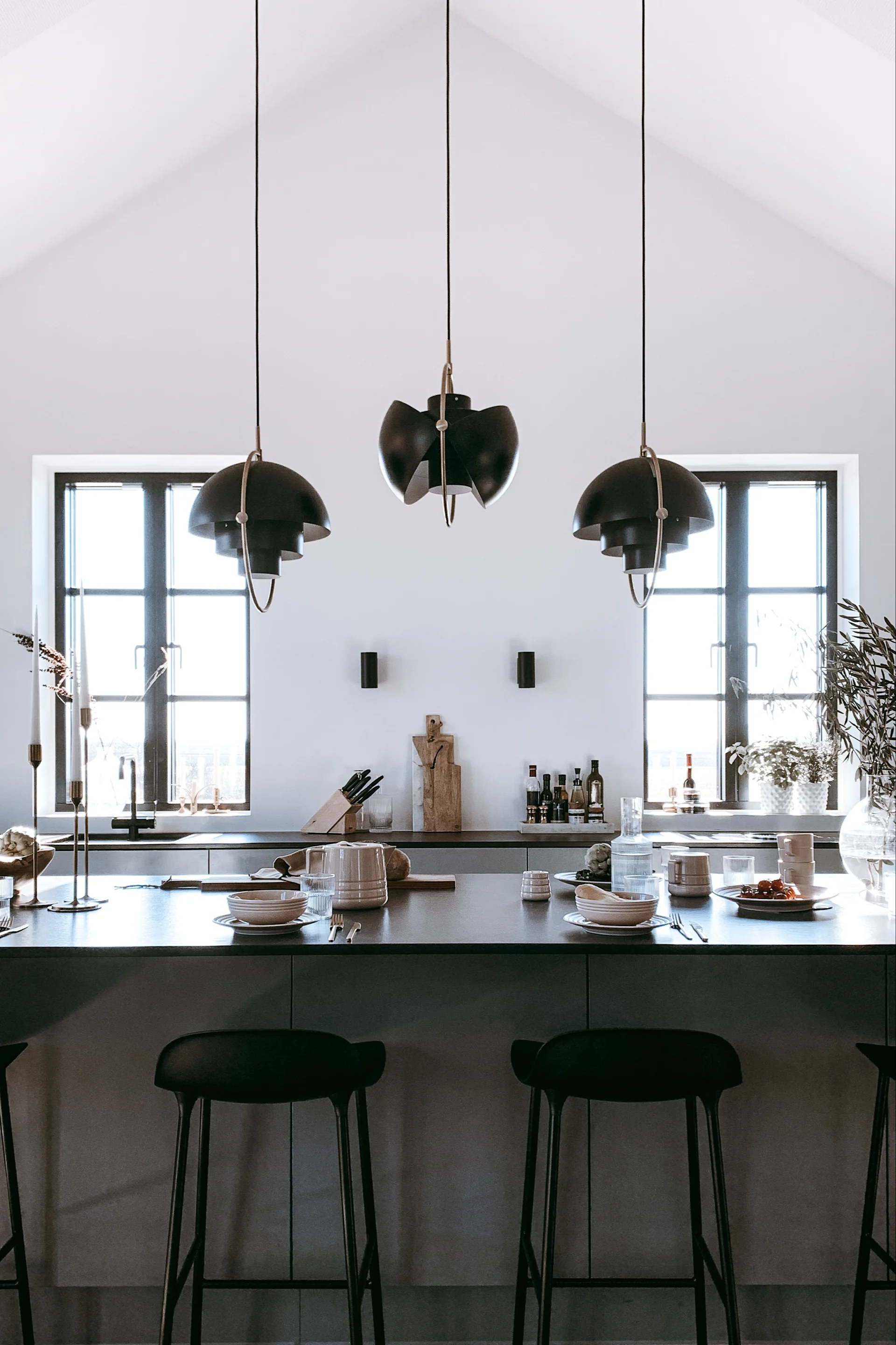 Consider whether you want mood or functional lighting in the kitchen. Here you see a collection of Gubi's Multi-Lite hanging in the kitchen of Swedish influencer @arkihem. 