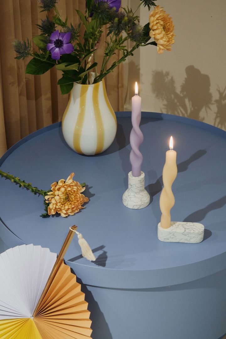 Twisted candles in lavender and lemon yellow on a sky blue table - Broste Copenhagen shows the colour trends for 2022.