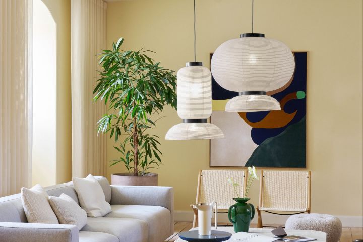 Here you see the Japanese style Formakami paper ceiling lamps designed by Jamie Hayon for &Tradition  in a soft yellow coloured living room.