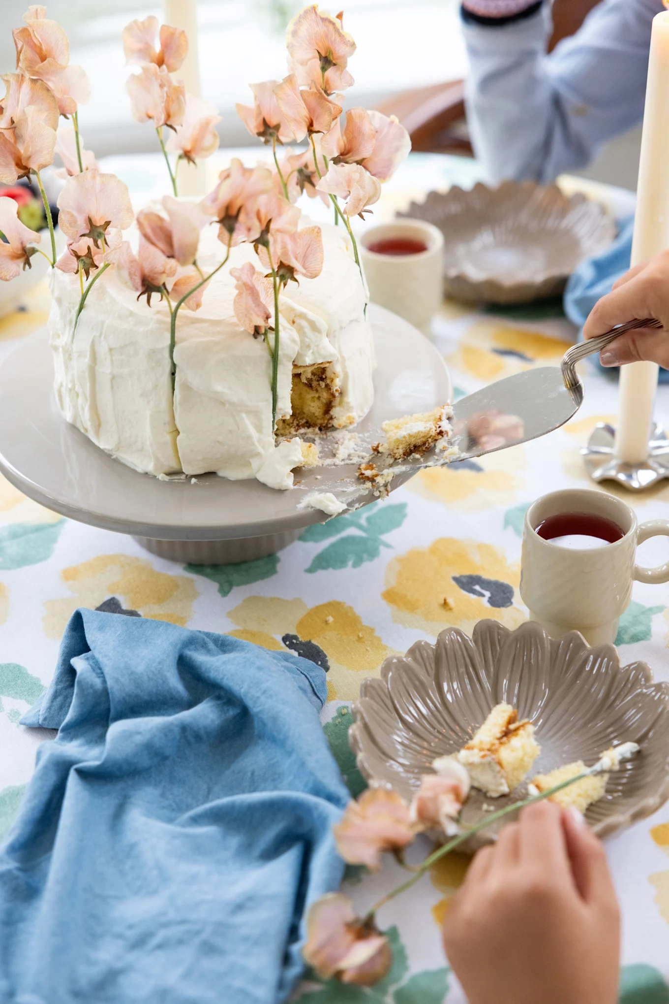 A colourful, spring-like table setting with a large cake, all from Sagaform.
