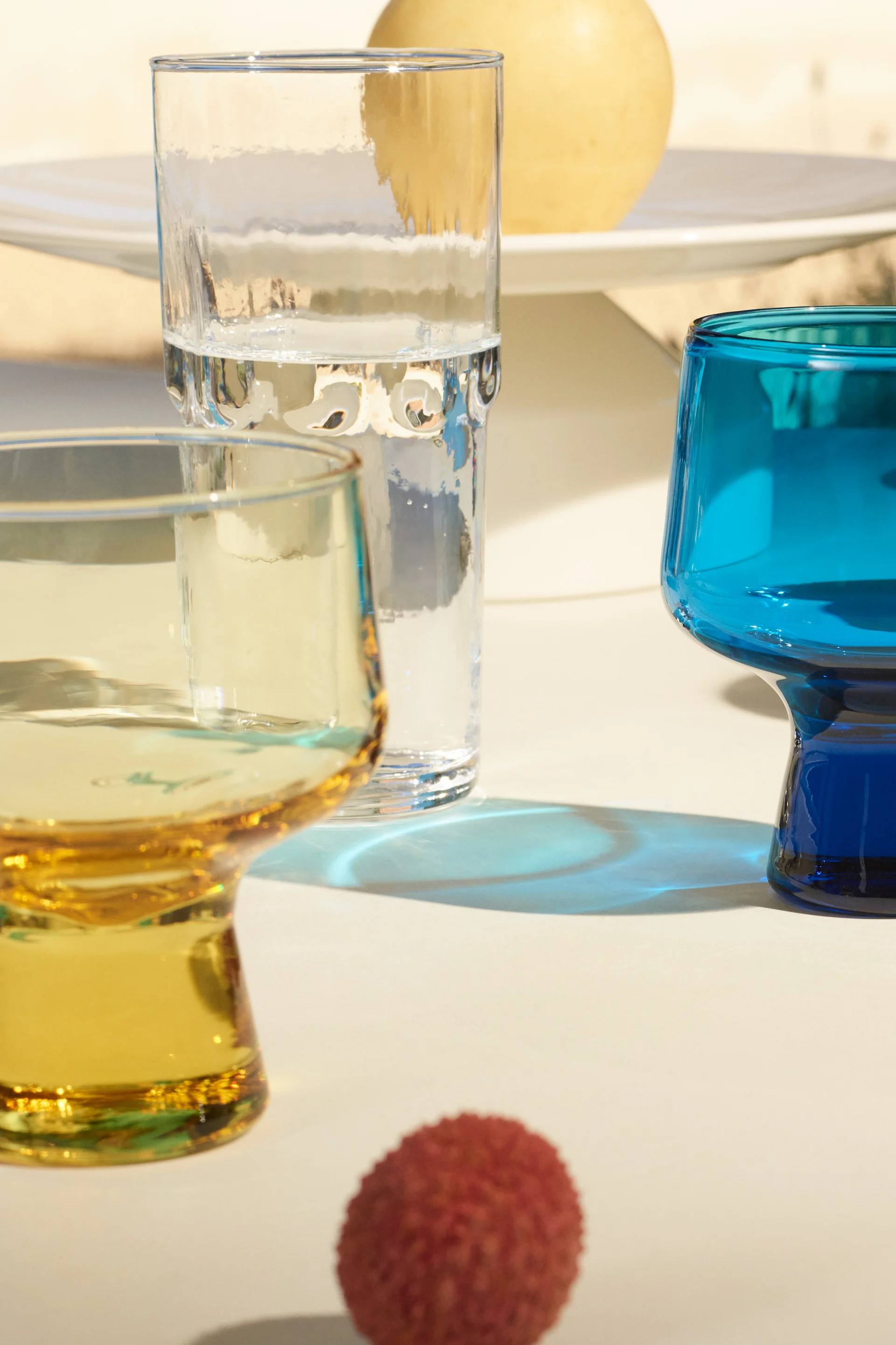 The new Solare collection from Iittala, here you see the yellow, blue and clear glasses in the collection shining in the sunshine. 