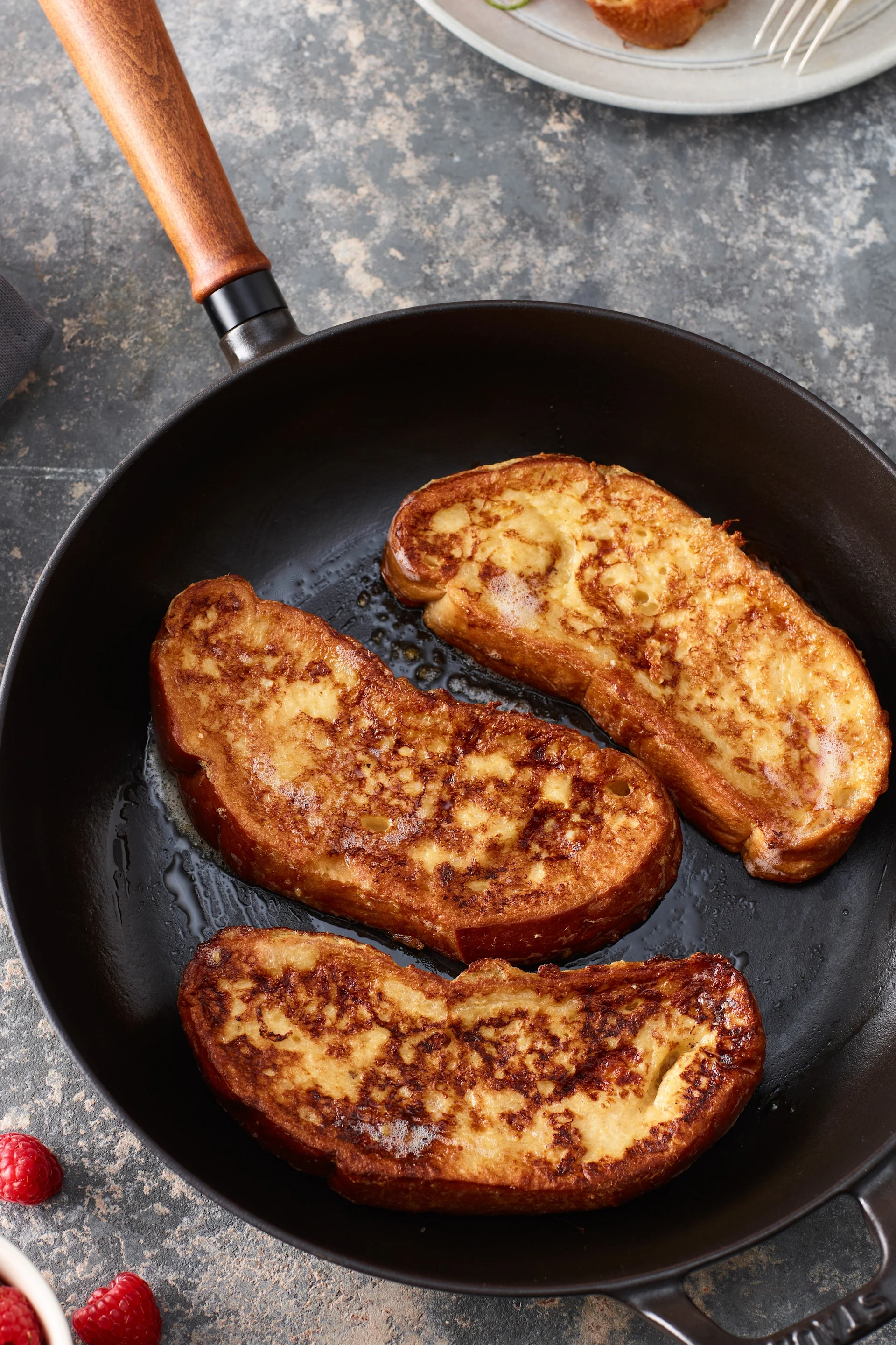 Slices of bread are fried in the vintage cast-iron pan from Staub.
