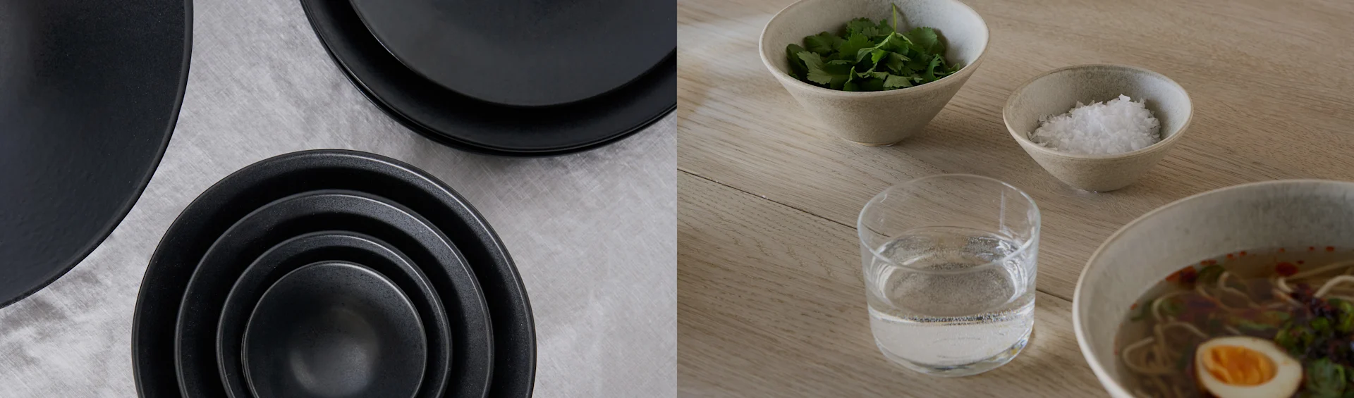 Black plates and bowls on grey fabric; ramen bowl with egg, cilantro, salt, and water on a wooden table.