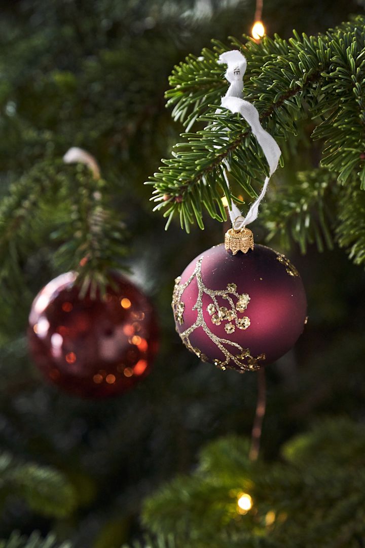 Burgundy And Silver Decorations On A Large Christmas Tree Stock