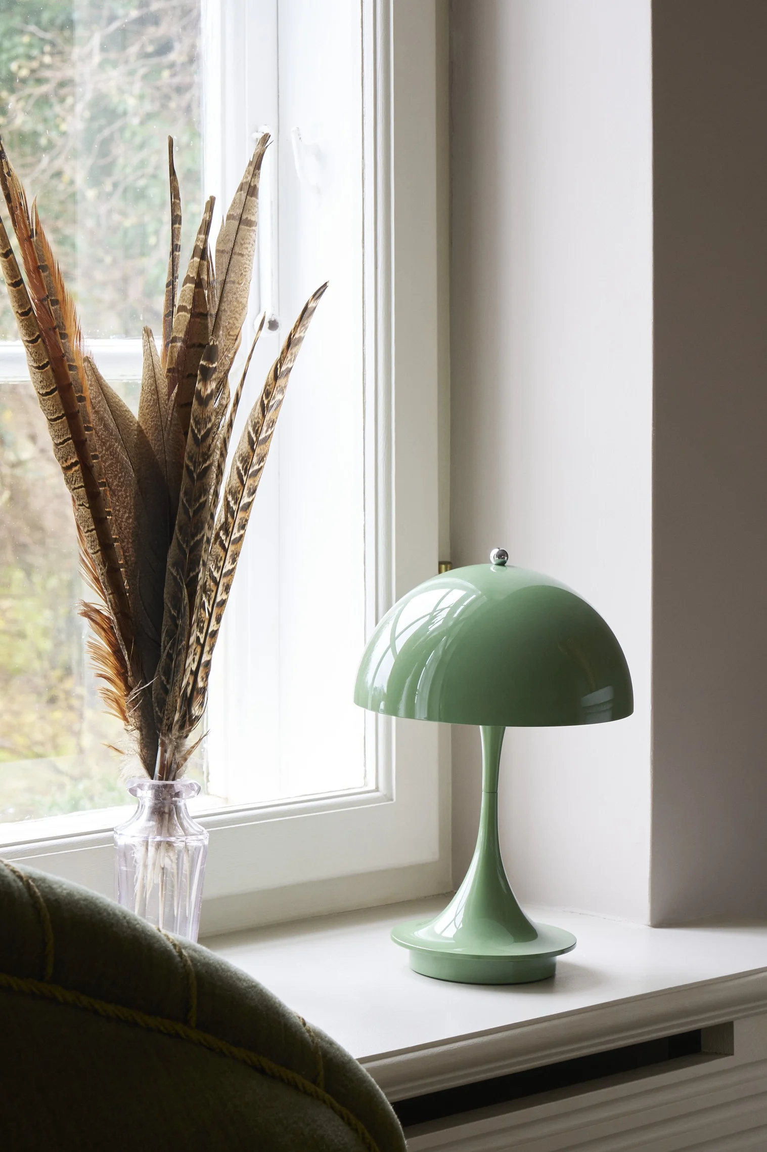 The colour sage is one of the interior design trends of autumn 2025. Here, the sage-coloured Panthella table lamp from Louis Poulsen stands on a windowsill.