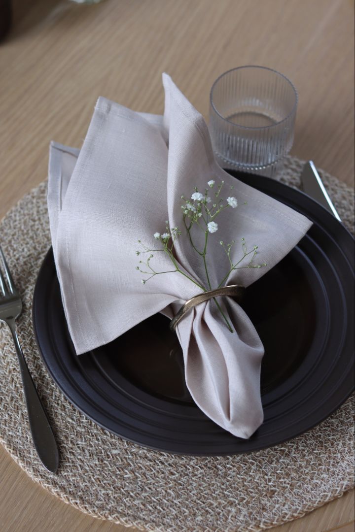 A napkin scrunched at the end and folded into a napkin ring.  