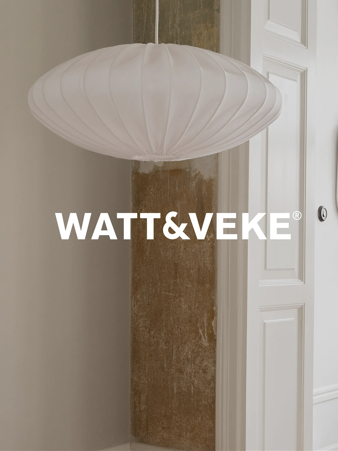 A white, pleated, oval-shaped pendant lamp hanging in a room, with WATT&VEKE logo.