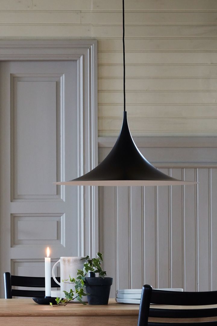 Here you see the Scandinavian design lamp Semi having over a dining table. 
