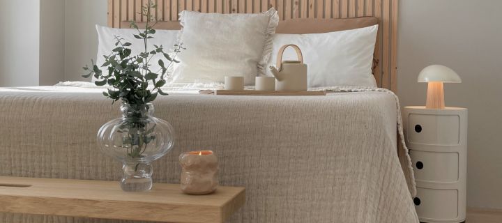 A Scandinavian style bedroom with neutral beige tones and natural wood.