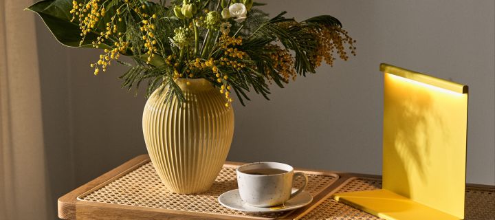 The interior design trends for spring 2023 offer colour, polka dots and statement vases, and we like to decorate with a colorful lamp, polka dot cup and yellow fluted vase.
