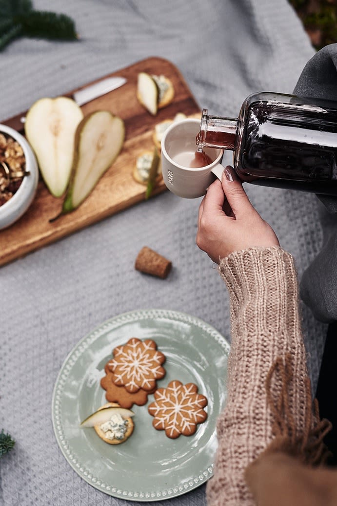 Homemade mulled wine, a classic Scandinavian Christmas recipe that is poured into white mulled wine mugs from ERNST.