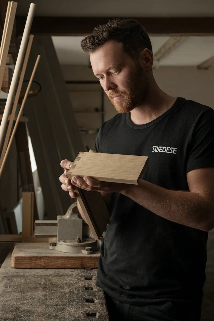 A man making furniture in Swedese furniture factory in Sweden.