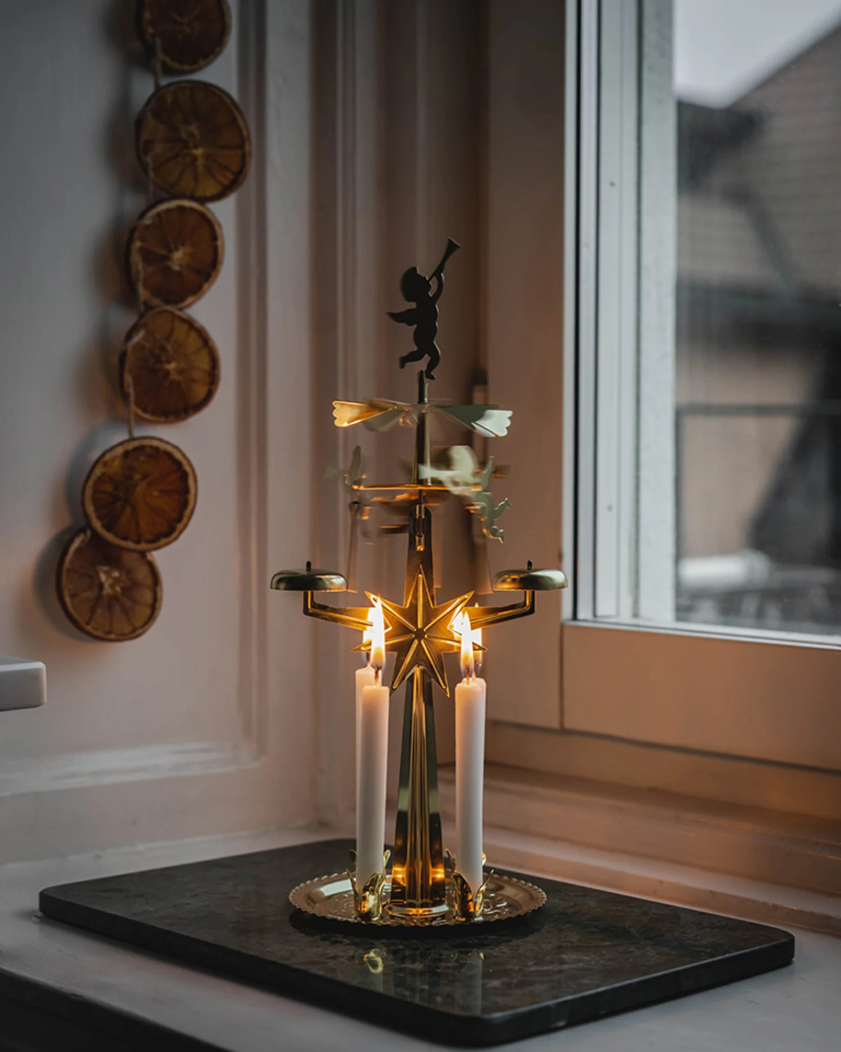 On a window sill stands an Angel Chime - a typical Christmas decoration in Sweden.