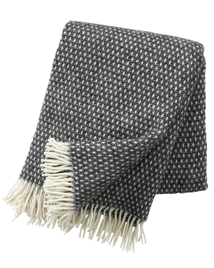 The dark grey Knut throw from Klippan Yllefabrik is always a favourite around the dining table. 