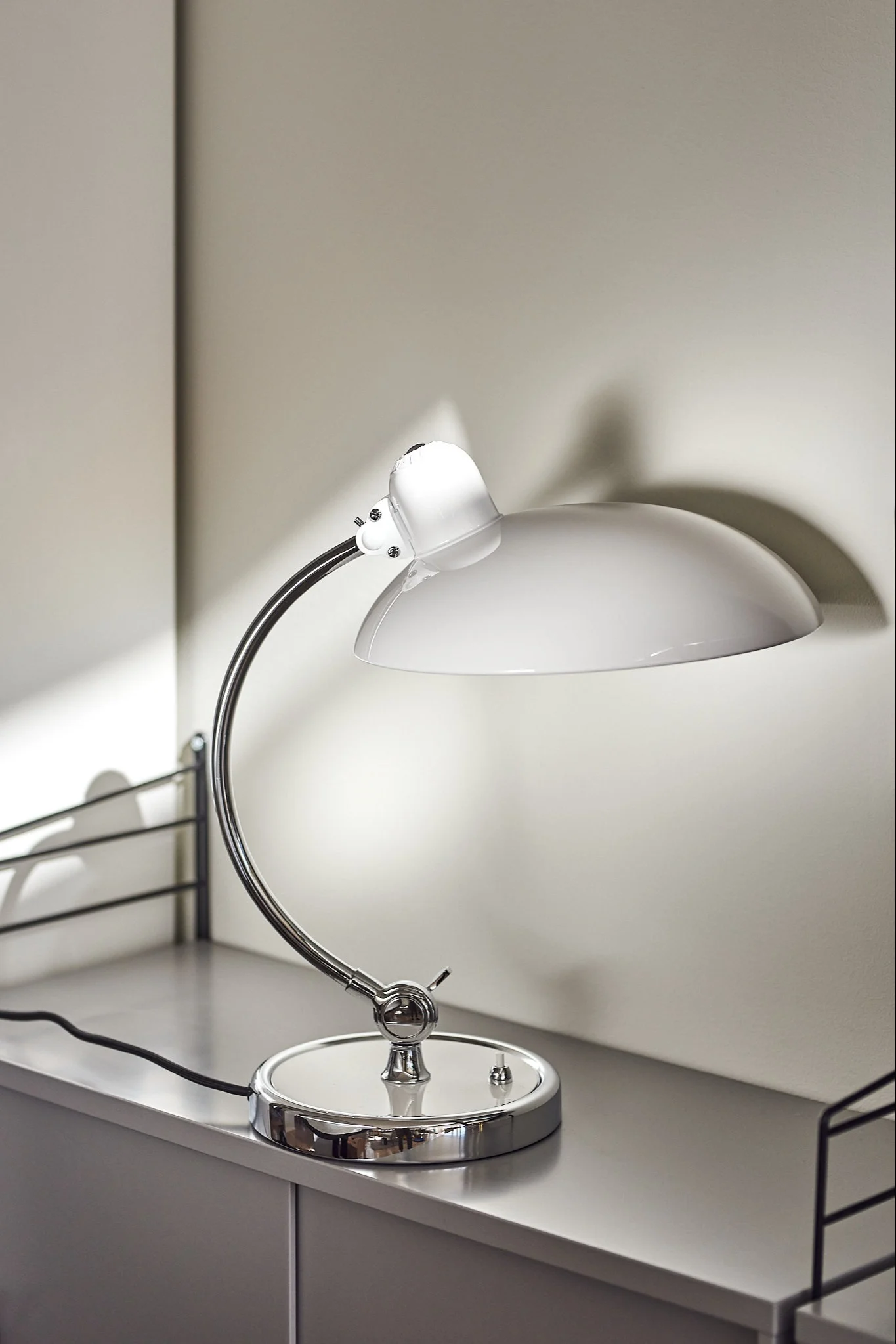 White table lamp from Fritz Hansen with chrome details.