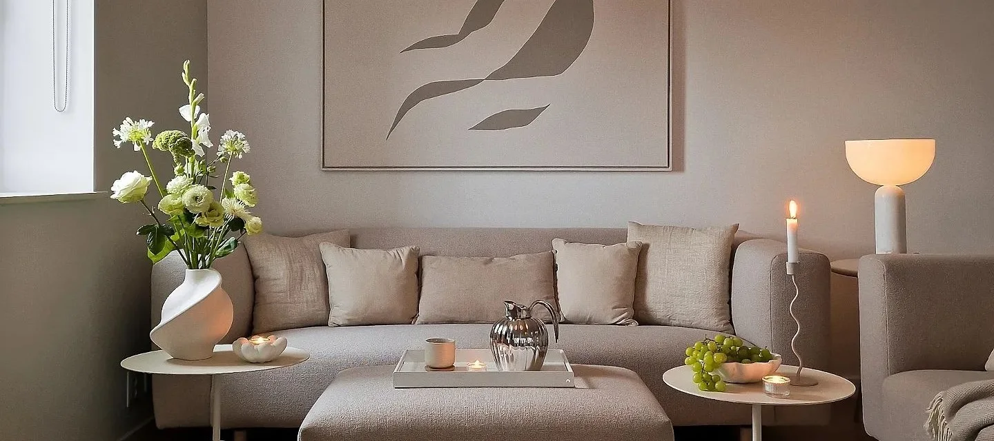 Create a cosy hygge living room with candles, neutral colours and natural materials.