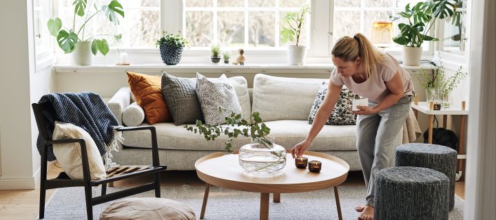 Create a cosy hygge living room with candles, neutral colours and natural materials. 