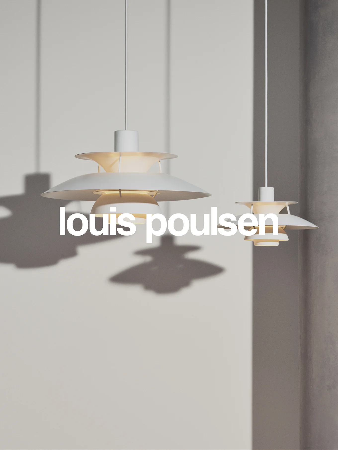 Two white, tiered pendant lamps hanging against a light gray wall, with the text 'louis poulsen'.