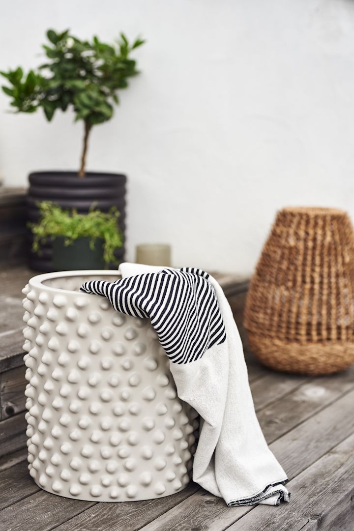 Plant pots are always a summer essential for the outside but have you thought about using them to store your pillows and throws? 