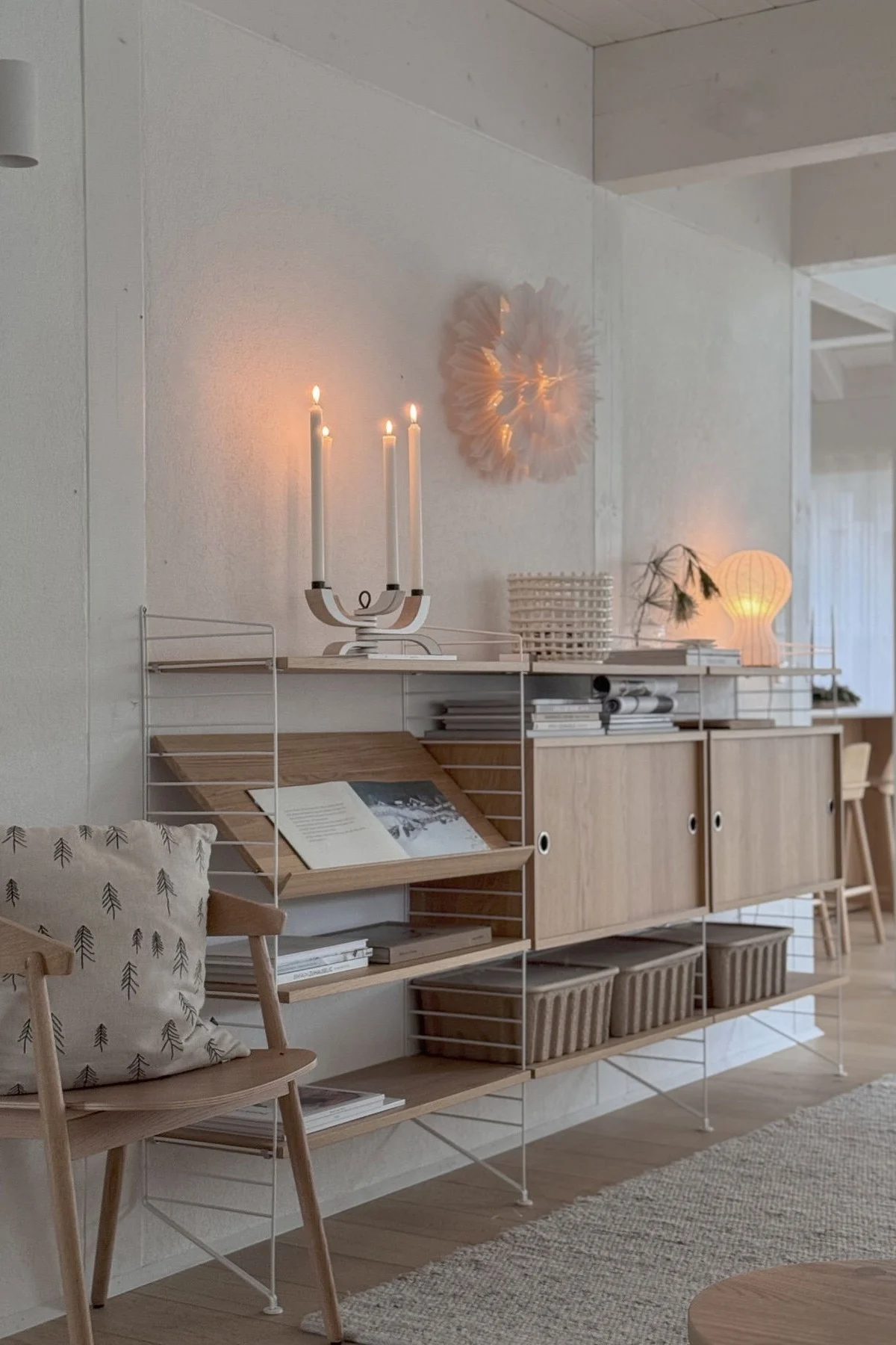 Minimalist Christmas decor embraces candlelight, here you see the Nordic Light candle holder from Design House Stockholm on a sideboard at the home of @Zuhauselig.