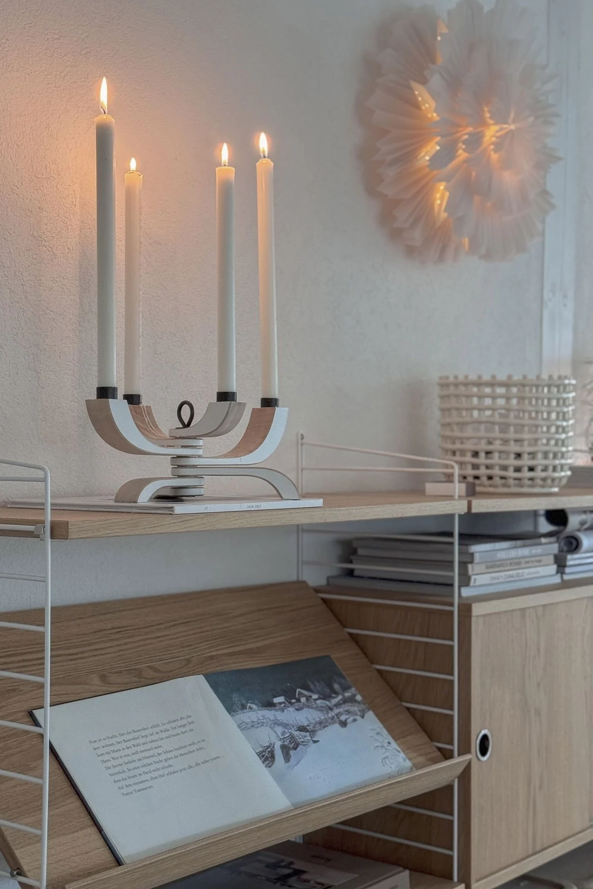 Minimalist Christmas decor embraces candlelight, here you see the Nordic Light candle holder from Design House Stockholm on a sideboard at the home of @Zuhauselig.