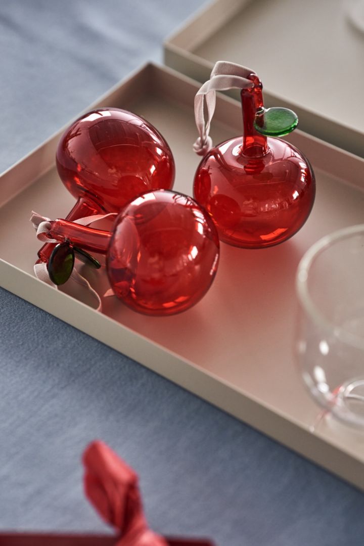 The Iittala red apple hanging Christmas ornament add a pop of candy red to the Share Christmas tablescape.  