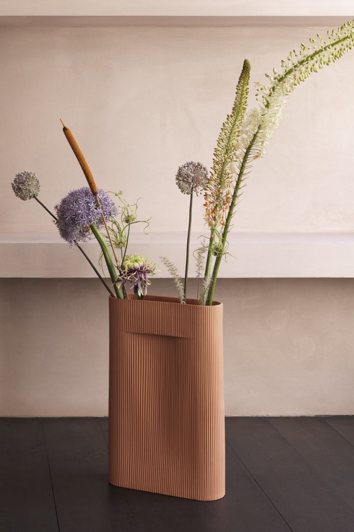 Terracotta ridge vase with flowers to bring life into the home. 