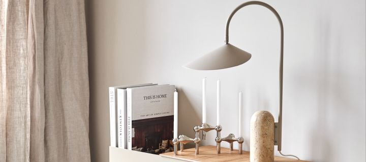 Renew your home with modern lighting ideas - here you see Arum table lamp from Ferm Living in tones of beige and marble next to Stoff Nagel candlestick in silver on Plant Box in beige from Ferm Living.