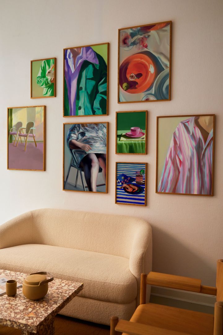 Posters that mimic paintings in lots of colour and retro motifs are right on target for the Scandinavian interior design trends in 2024 - here's a gallery wall with them from Paper Collective. 