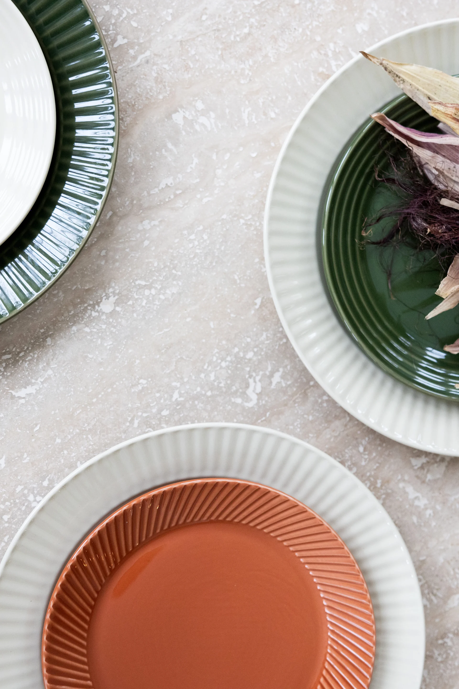 Different coloured plates from the Coffee & more collection by Sagaform on a table.