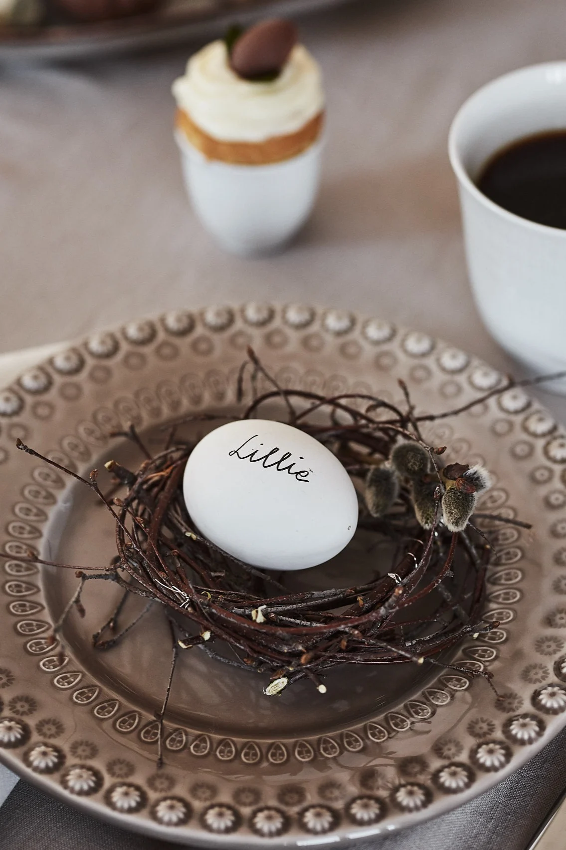 For Easter, make a small bird's nest out of birch twigs, place it on a plate and put an egg labelled with your name in it.