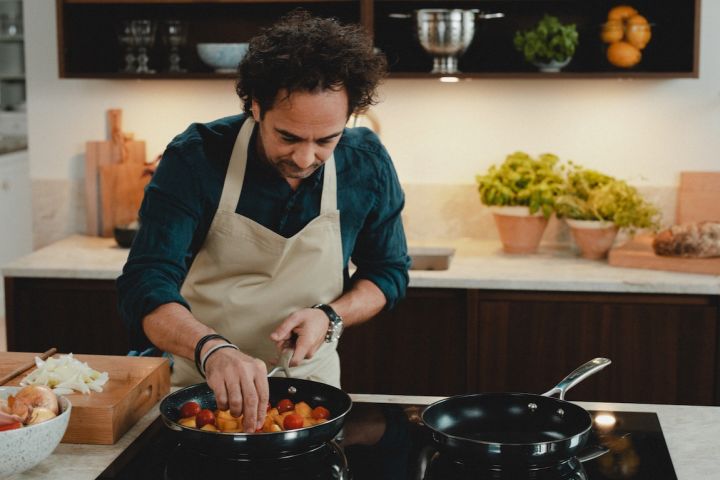 Chef Markus Aujalay cooks in his kitchen with frying pans from his own brand of cooking products in an with Nordic Nest.