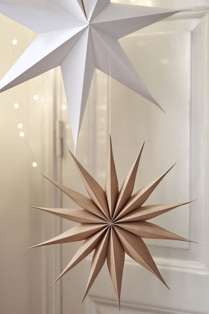 Venok Christmas star from Broste Copenhagen hangs in a star cluster in the living room.