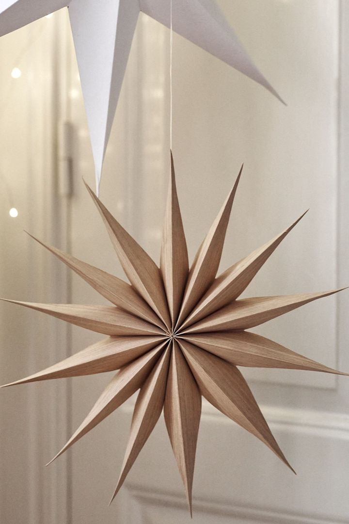 Venok Christmas star from Broste Copenhagen hangs in a star cluster in the living room.