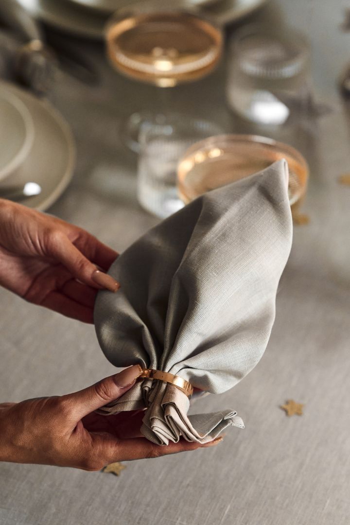 New Year party ideas - fold your napkins like you see here for an elegant finishing touch to the table setting. 