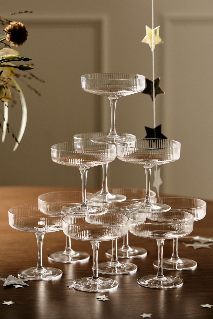 Discover how to build a champagne tower like the one you see here with three tiers and the Ripple coupe glasses from ferm Living. 