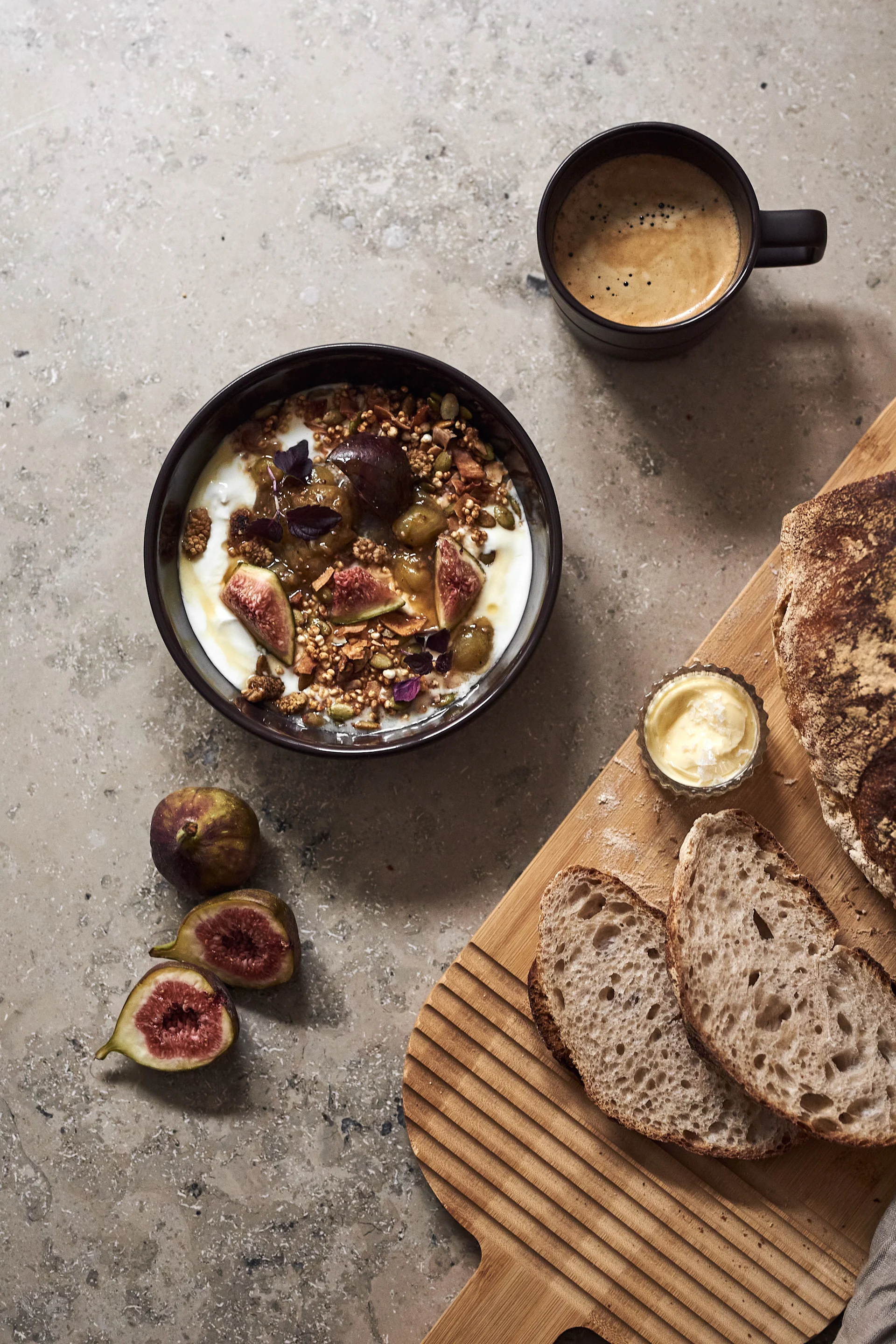 The NJRD Lines bowl in brown with müsli, sliced bread and a cup of coffee. 