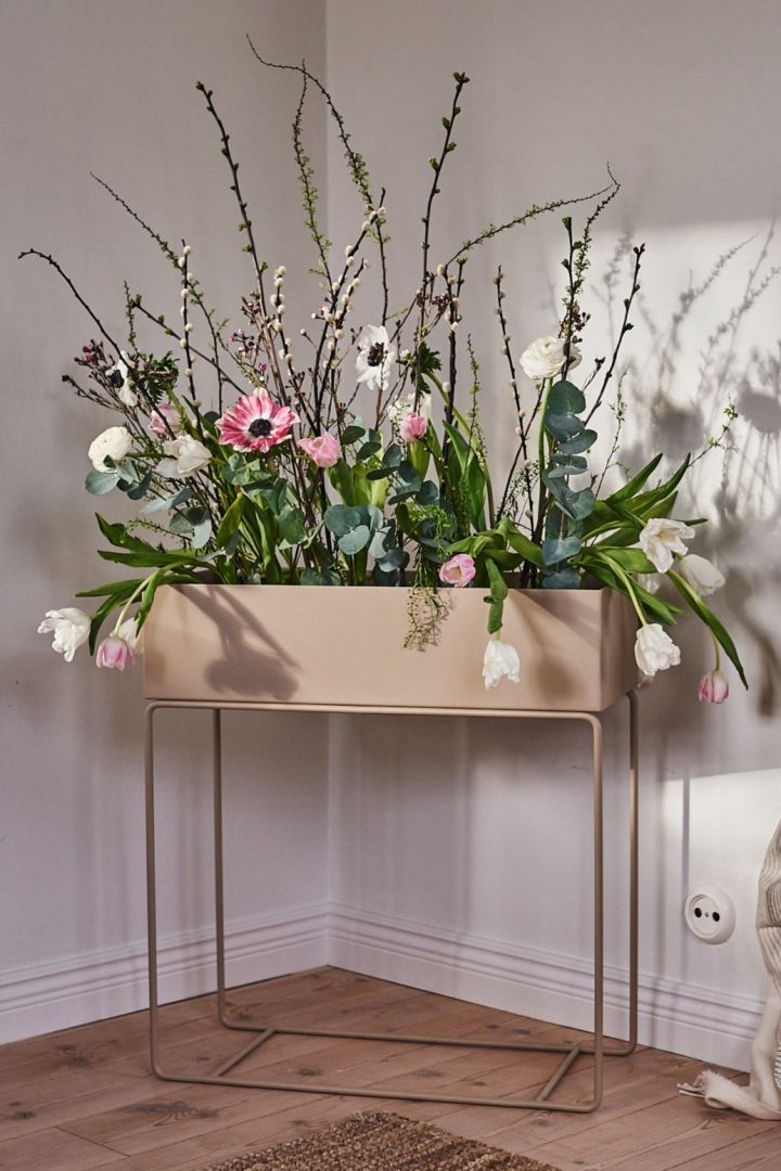 A beautiful arrangement of fresh flowers that looks like an indoor flower bed in ferm LIVING's iconic plant box. 