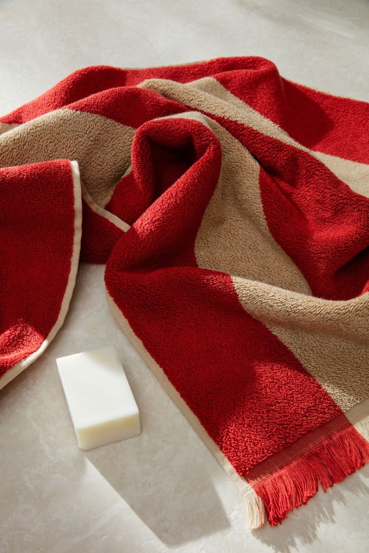 An interior design trend for the future, stripes and dark red tones. Here you see the Alee towel from Ferm Living. 