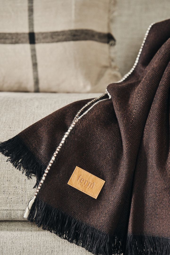 Herringbone throw in dark brown from Ferm Living with the beautiful label in focus.