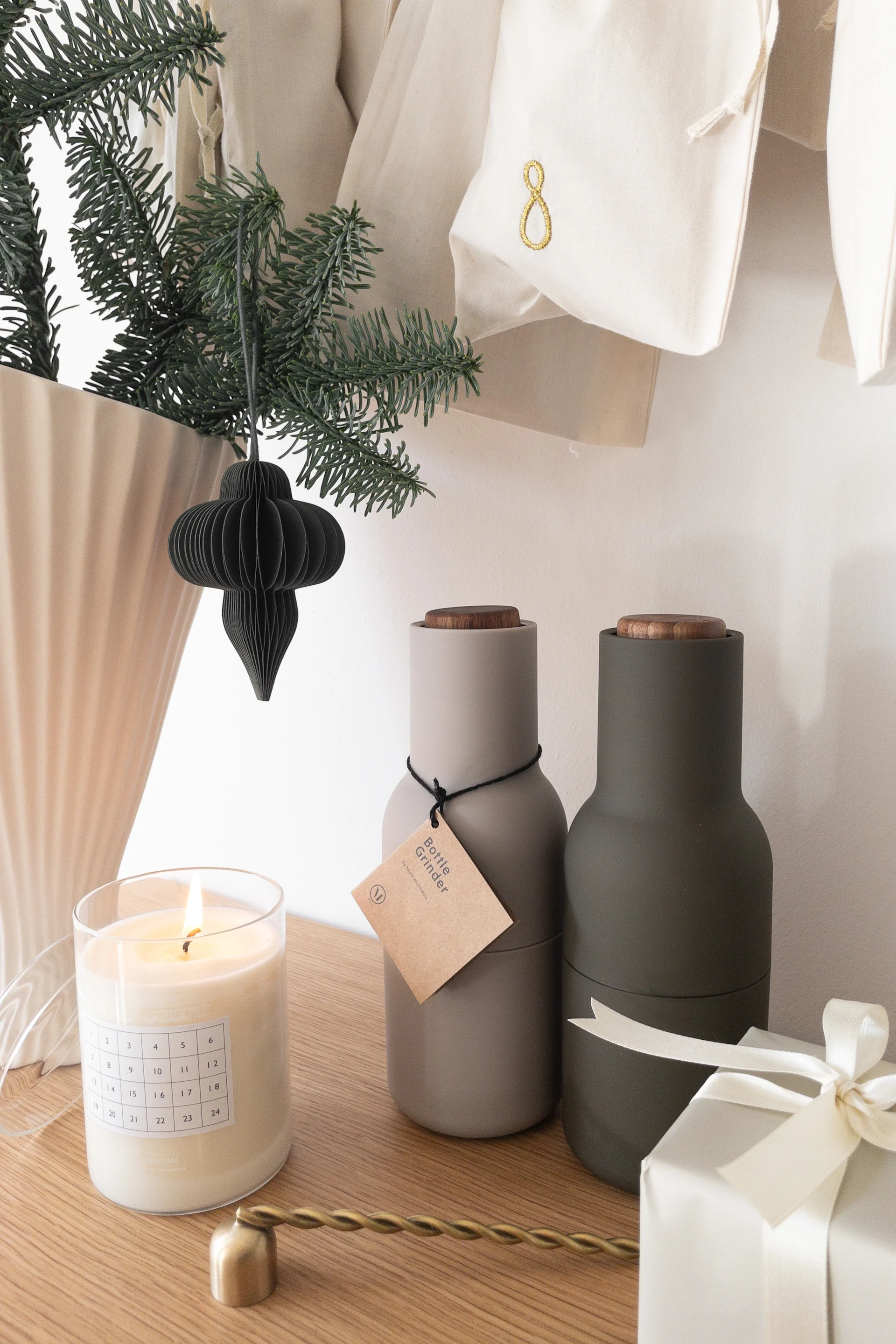 Christmas gift ideas like the Bottle Grinders you see here in a neutral coloured christmas scene are perfect for foodies. 