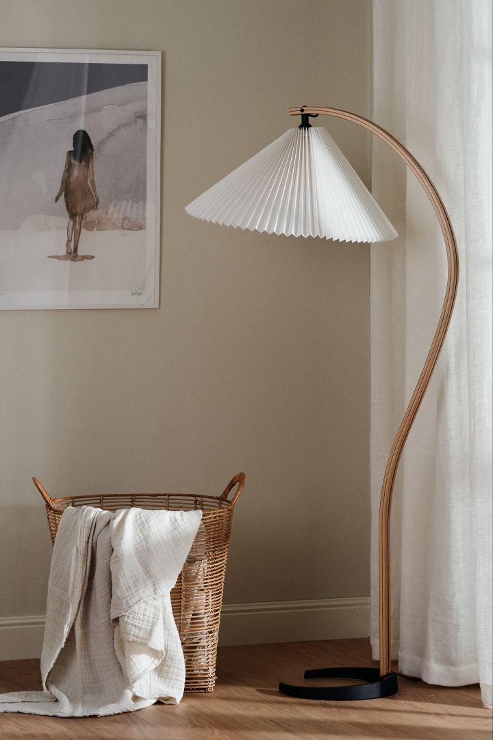 The interior design trends for spring 2023 offer retro-style pleated lamps, where we like to decorate with the trendy floor lamp from Gubi with a white pleated lampshade.