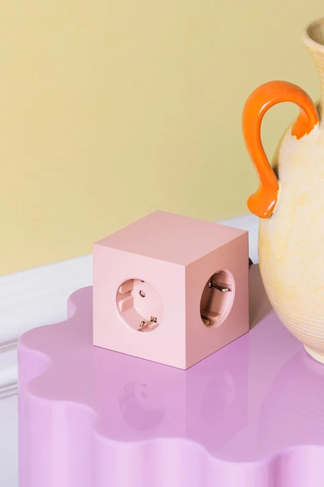 Spring 2024 interior design trends offer colourful interior details, even a power strip can be in colour, here square power strip in pink from Avolt.