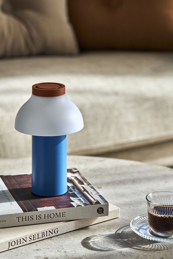 Spring interior trends 2023 offer colourful interior details and we like to decorate with a colourful lamp and preferably portable such as PC Portable from HAY.