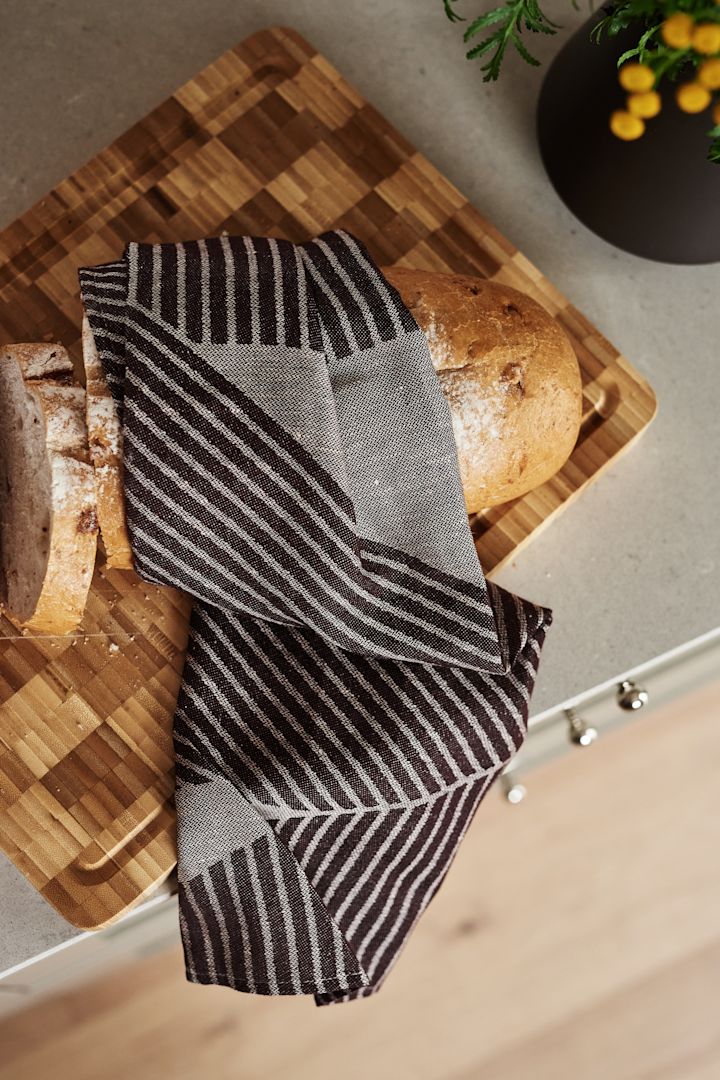 Renew your kitchen with 11 practical and stylish kitchen accessories for easier cooking - here you see the stylish Stripes kitchen towel from NJRD in brown and white.