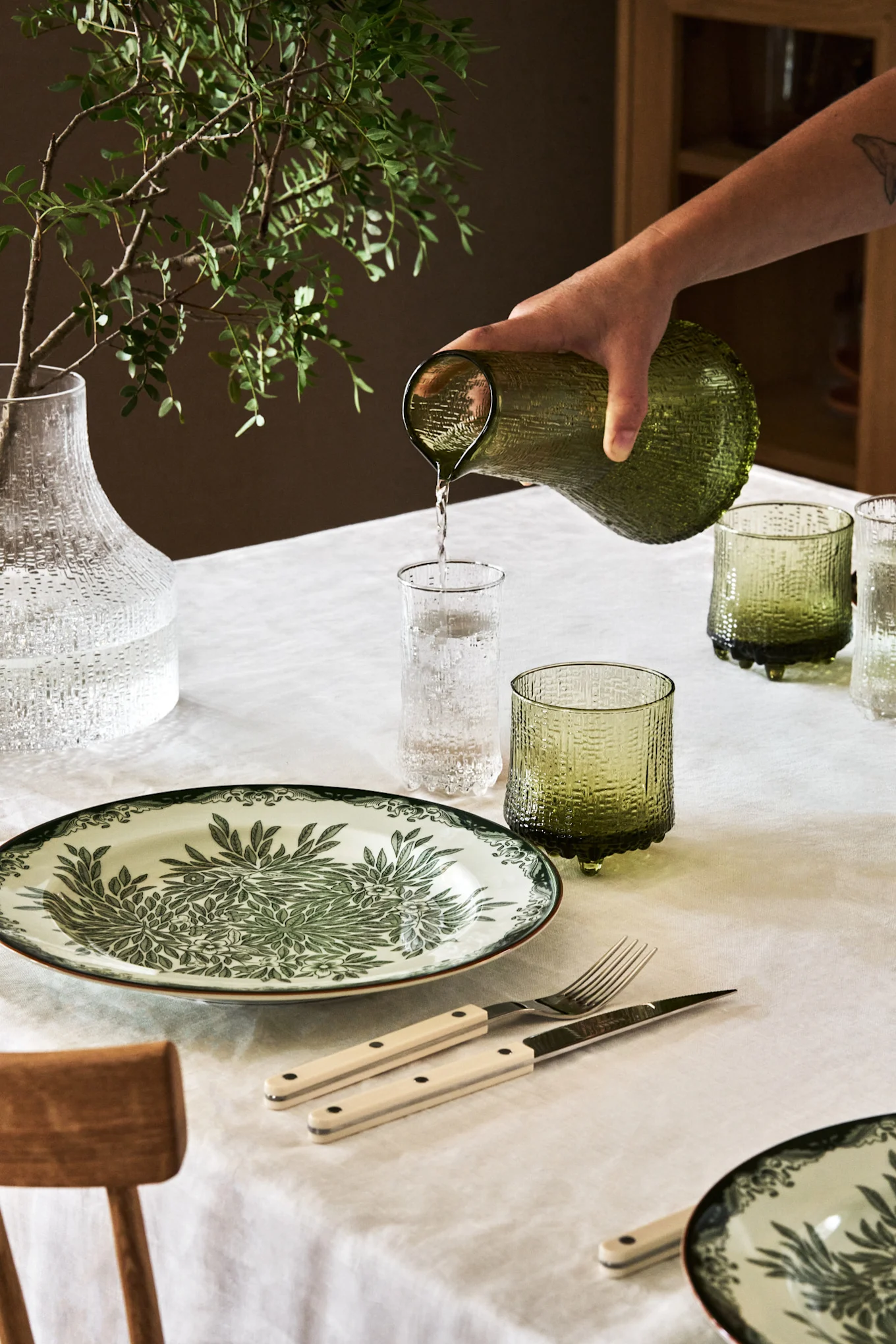 Here, the Ultima Thule collection from Iittala in a lovely natural green on a dining table.